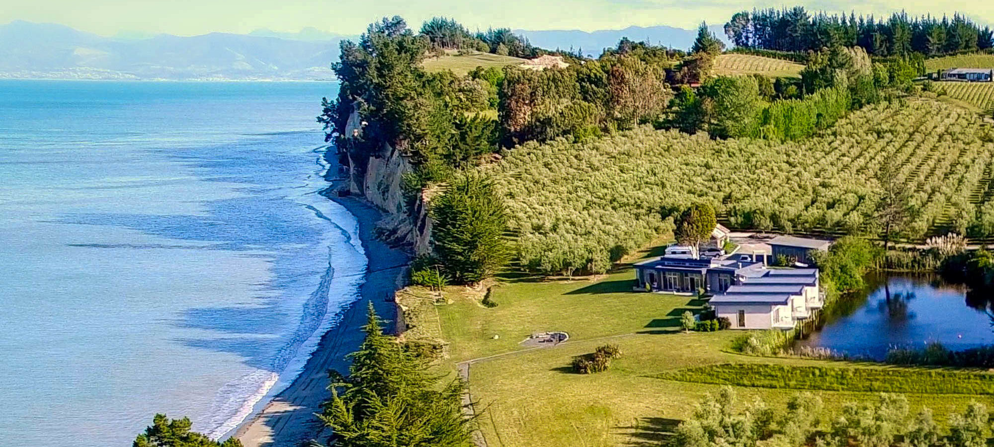 The cliffs of Kina Peninsula and The Windhover Estate on the top right corner. The property in the front is The Waters BnB which is located on the same property.